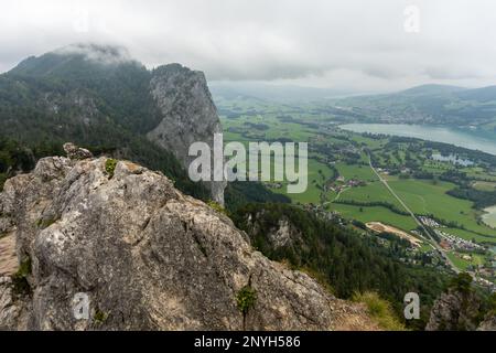 View of the lake and town Mondsee, with mountain Drachenwand to the left, in cloudy weather, as seem from Almkogel Stock Photo