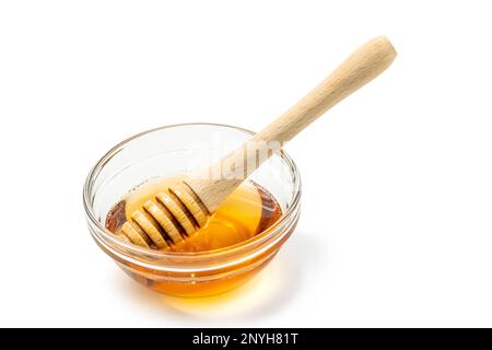 Honey bowl and dipper isolated on white background as package design element. Clipping path included. Stock Photo