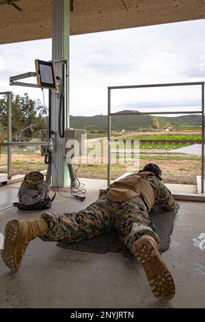 U.S. Marine Corps Lance Cpl. Gabriel Oreaiglesias fires an M-16A4 service rifle at Hathcock Range on Marine Corps Air Station Miramar, Jan. 30, 2023. Oreaiglesias, a native of Whittier, California, is a transmissions system operator for Marine Wing Communications Squadron 38, Marine Air Control Group 38, 3rd Marine Aircraft Wing. Hathcock Range uses an innovative Location of Miss and Hit low-bar system, which can track shots on the target within a deviation of 17 millimeters. Stock Photo