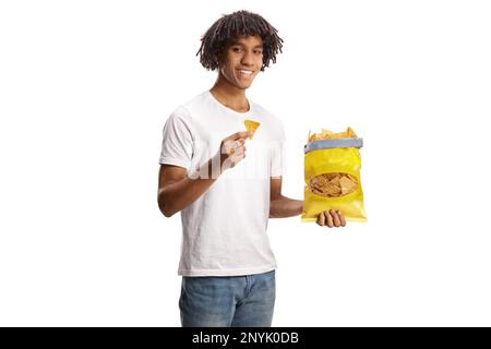 Young african american man eating tortilla crisps and smiling isolated on white background Stock Photo