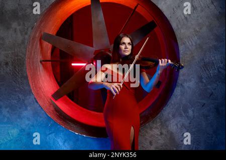 Violin player performing solo over loft interior background Stock Photo