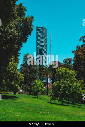 Eureka Skydeck tower viewed from King's Domain park behind the tall spoke structure of Arts Centre Melbourne. Victoria, Australia. Stock Photo