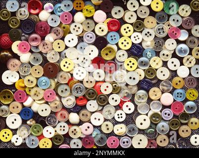 Lot of colorful plastic clothing buttons. Many small round vintage buttons pattern background Stock Photo