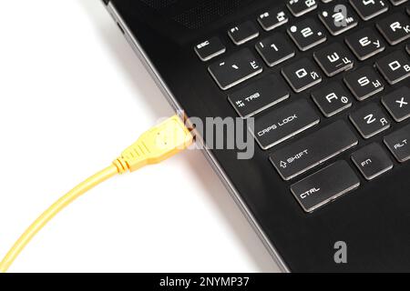 laptop with USB orange cable Stock Photo