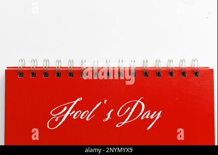 Red notebook with text FOOL'S DAY on white background. Fool's day celebration concept Stock Photo