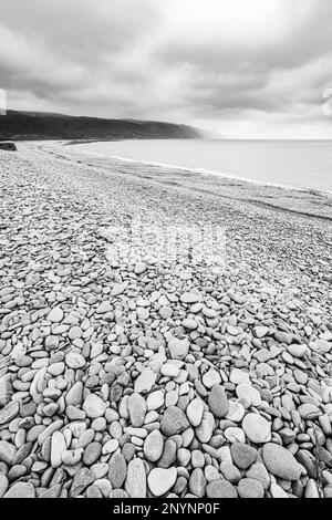 The stony beach at Bossington (looking towards Porlock Weir) on the north coast of Exmoor National Park, Somerset, England UK Stock Photo