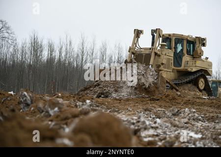 Soldiers from the 1432nd Engineer Company, Michigan National Guard use heavy equipment to move dirt during Northern Strike 23-1, Jan. 27, 2023, at Camp Grayling, Mich. Northern Strike’s winter iteration offers units a chance to train in a joint, all-domain, cold-weather environment. Stock Photo