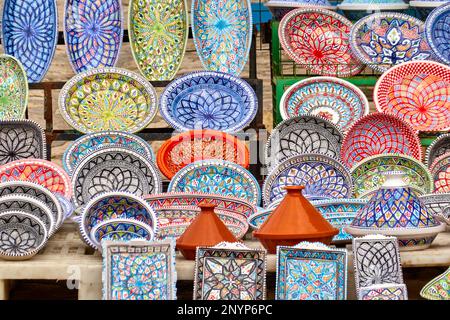 Sousse, Tunisia, February 2, 2023: Finely painted and decorated colorful ceramic plates and crockery at a stall in the Sousse souk in the medina, clos Stock Photo