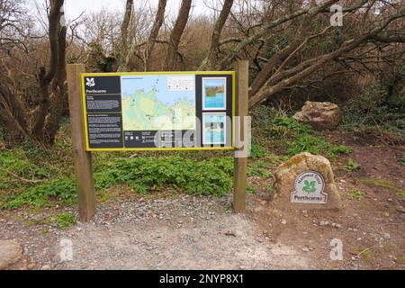 National Trust information sign at the start of the path to the beach at Porthcurno, Cornwall, UK - John Gollop Stock Photo