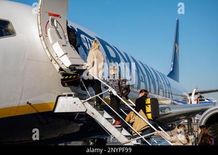 Passengers stepping into Ryanair Boeing 737-800 airplane at London Stansted Airport in Essex, England Stock Photo