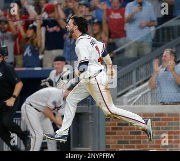 Dansby Swanson #7 of the Atlanta Braves looks on from third base during a  pitching change in the sixth inning during MLB g…