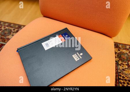 Paris, France - Mar 1, 2023: new 2023 Collins appointments planner from the UK's leading diary and stationery supplier on the luxury orange armchair Stock Photo