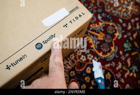Paris, France - Dec 13, 2022: pointing to Spotify radio streaming service Cardboard of new Onkyo NS-6170 network audio player with DSD Hi-Res Audio and DSD DAB plus WIFI device Stock Photo