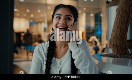 Smiling arabian middle-eastern woman buyer customer student businesswoman ethnic girl lady spend weekend at shopping mall business center answer Stock Photo
