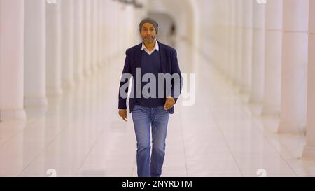 Businessman walks down a hallway - street photography Stock Photo