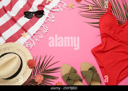 Frame made with different beach objects on pink background, flat lay. Space for text Stock Photo