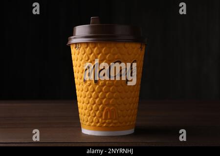 MYKOLAIV, UKRAINE - AUGUST 12, 2021: Hot McDonald's drink on wooden table Stock Photo