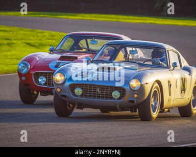 1961 Ferrari 250 GT SWB/C and 1962 Ferrari 250 GT SWB racing at the Goodwood Revival 2022, West Sussex, uk Stock Photo