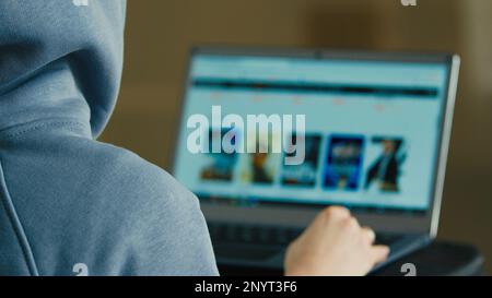 Computer screen view over shoulder unknown unrecognizable man back businessman engineer programmer hacker specialist search information online Stock Photo
