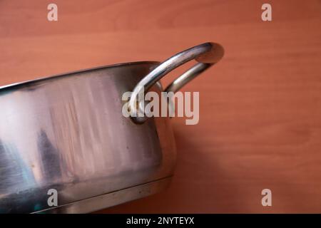 empty kitchen gray pan stands on a table Stock Photo