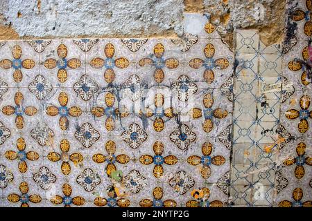 LISBON, PORTUGAL - OCTOBER 20, 2022 close up of traditional tiles on a wall with damage and grunge Stock Photo