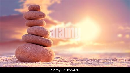 Stone tower. Natural pebble stone on the beach. Balancing body, mind, soul and spirit. Mental health practice. Stock Photo