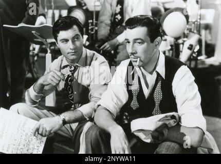 American actors George Montgomery and Cesar Romero in the movie Orchestra Wives, USA 1942 Stock Photo