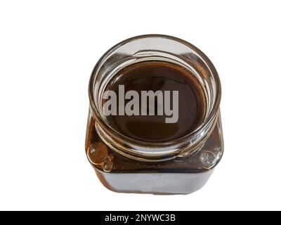 Chestnut honey in a jar isolated on white background Stock Photo
