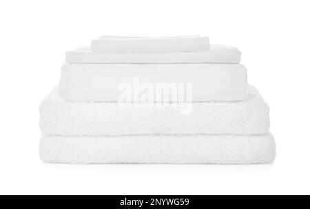 Stack of towels and bed sheets on white background Stock Photo