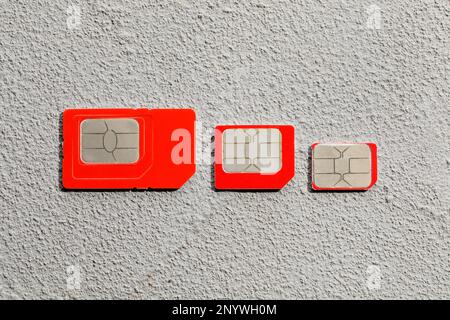 Different SIM cards on stone background, flat lay Stock Photo