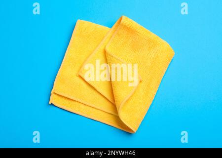 Orange microfiber cloth on light blue background, top view Stock Photo