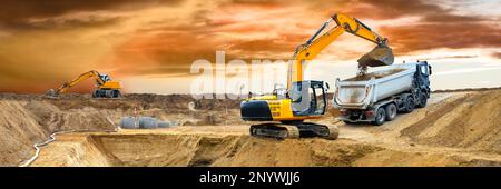 excavator ist digging and working at construction site Stock Photo