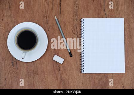 Office stuff with laptop and coffee cup notepad top view shot. Stock Photo