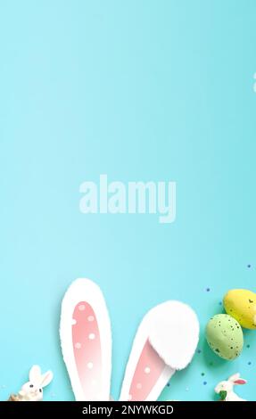 Easter decoration on a blue background. Bunny and eggs. Top view. Copy space Stock Photo