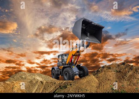 excavator ist digging and working at construction site Stock Photo