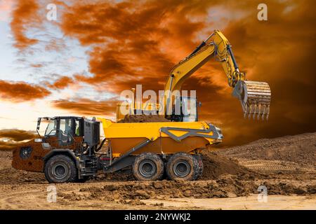 excavator ist digging and working at construction site Stock Photo