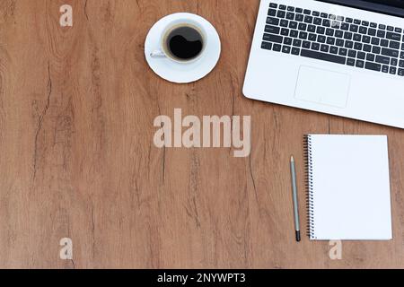 Office stuff with laptop and coffee cup notepad top view shot. Stock Photo