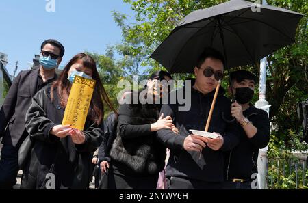 Chris Tam, partner of Abby Choi Tin-fung, holding joss stick, and other family members, including Choi's mother (middle) and her father (left), head to the crime scene to mourn the socialite at Lung Mei Village, Tai Po.  A headless body, which was believed to be Choi, was found. Police suspect she was murdered and dismembered by the family of her ex-husband. 28FEB23    SCMP / Elson Li Stock Photo