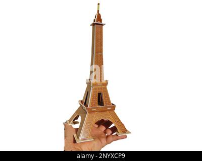 a person holds in his hand the Eiffel Tower made of 3d puzzle Stock Photo
