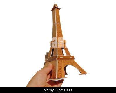 a person holds in his hand the Eiffel Tower made of 3d puzzle Stock Photo