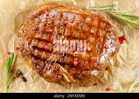 Fried steak close up, tasty, restaurant. Spiced with peppercorns and herbs. Top view Stock Photo