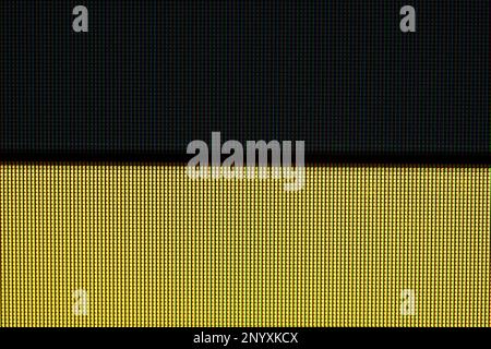 Black and yellow stripes, lines, LCD TV computer screen monitor pixels extreme closeup detail, abstract two color digital display background texture p Stock Photo