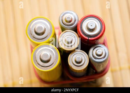 A bunch of generic old rechargeable alkaline batteries of different sizes, group of objects up close macro extreme closeup, energy storage, power, saf Stock Photo