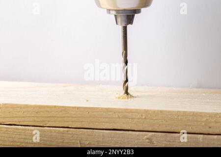 Close-up of a drill bit making a hole in wood Stock Photo