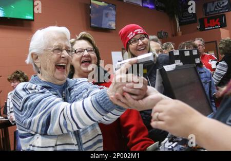 Audrey Hilgendorf of West Bend left smiles as she watches a man