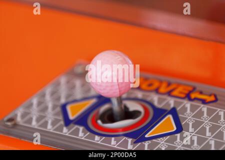 Close-up on the joystick of a toy crane. Stock Photo