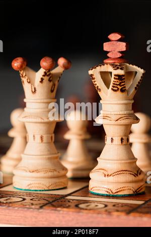 Wooden King and Queen on Chessboard Stock Photo