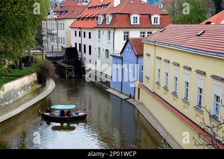 boat in Certovka (Devil´s canal). In background water wheel of Great Prior´s Mill. In Kampa Island. Malá Strana quarter.Prague. Czech Republic Stock Photo