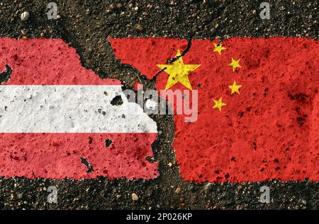 On the pavement there are images of the flags of Austria and China, as a confrontation between the two countries. Conceptual image. Stock Photo