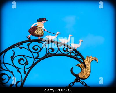 Colmar, France - December 13.2021: Image of a shepherdess with three geese in Colmar, Alsace, France Stock Photo